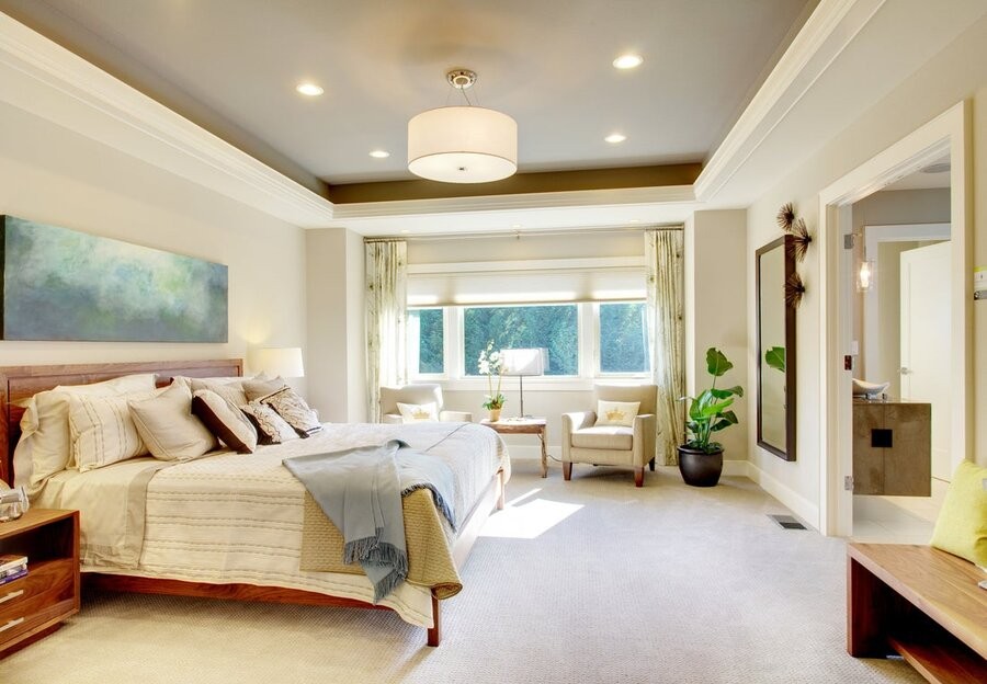 A bedroom illuminated by smart lighting control.