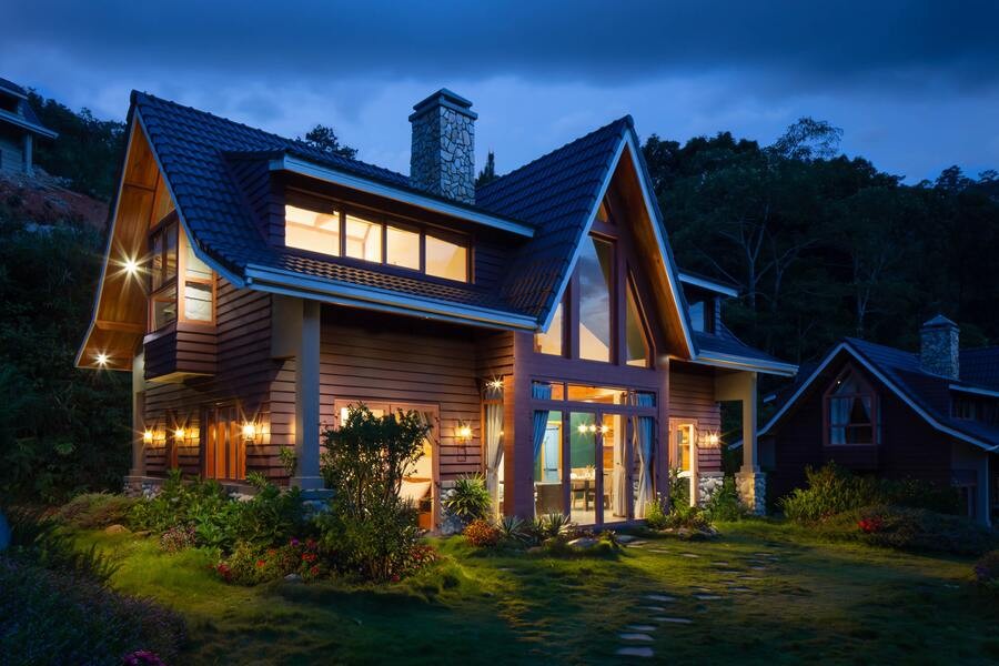 A luxury home illuminated by outdoor lighting solutions.